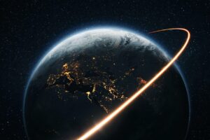 Earth illuminated at night with a glowing orbital path, symbolizing global connection and unity, reflecting the mission of the Hearts United Charity Gala.